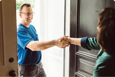 technician shaking hands with home owner