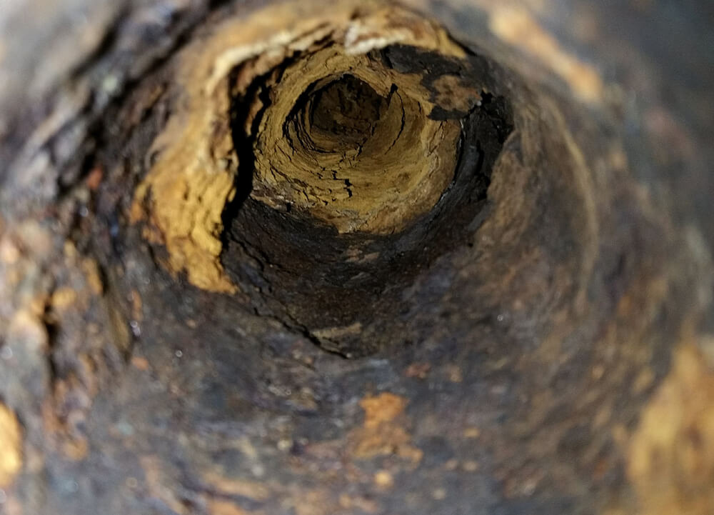 rusty insides of an old sewer pipe