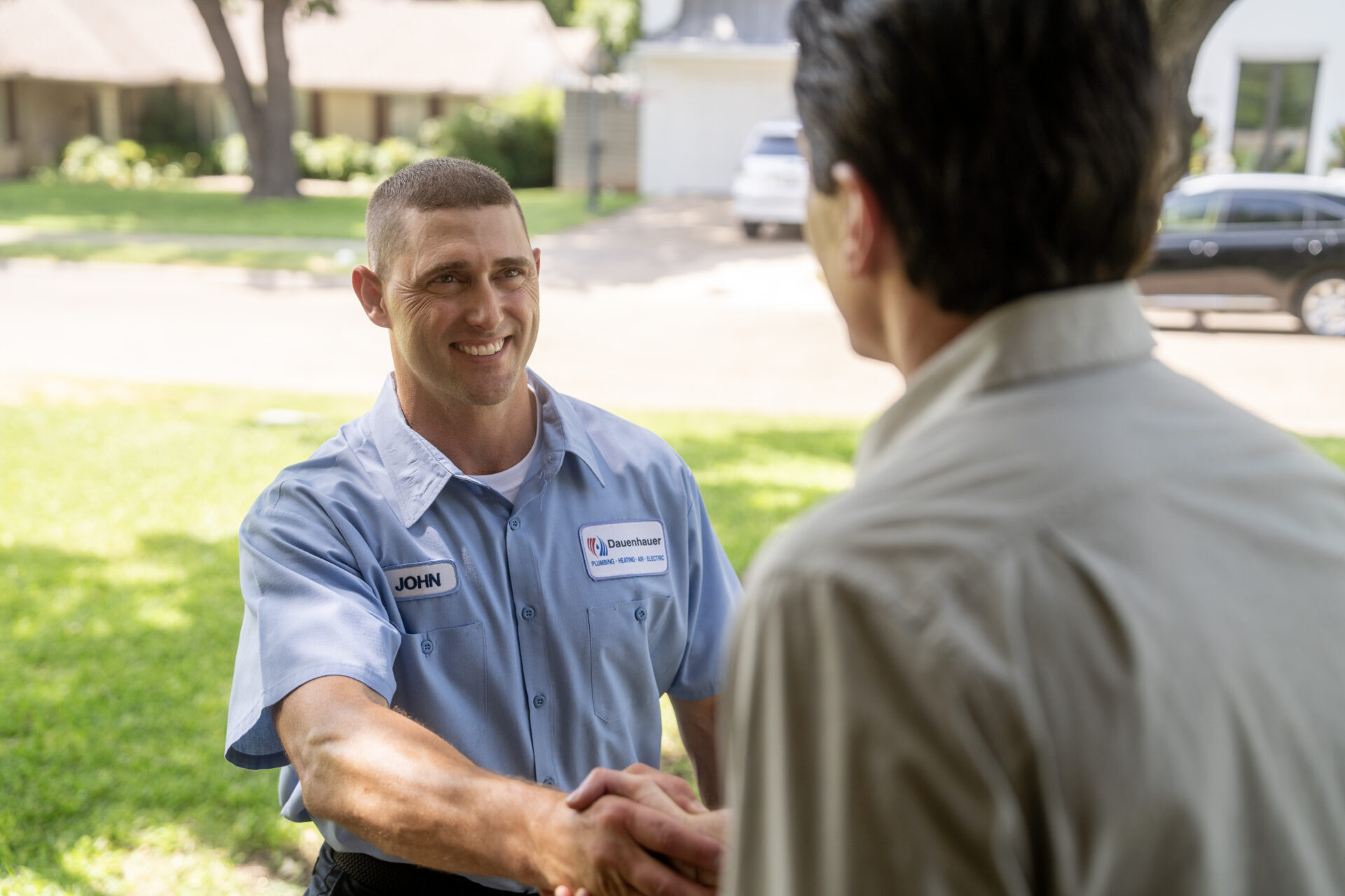 Dauenhauer Plumber shaking hands with homeowner