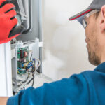 Technician servicing furnace for repairs