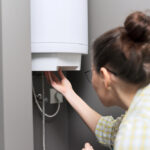 Woman turning on water heater